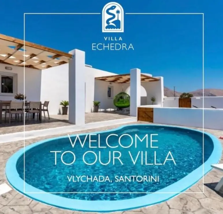 White villa in Santorini featuring a blue swimming pool, outdoor patio, and clear blue sky.
